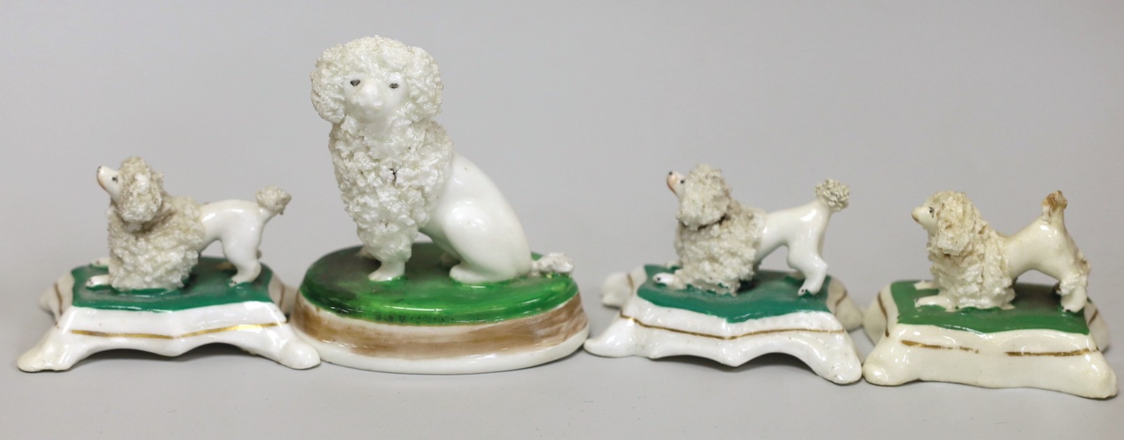 Four small Staffordshire models of poodles, c.1830-50, tallest 7cms high, Provenance Dennis G.Rice collection